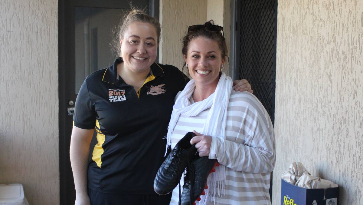 COMING TOGETHER: Hannah Burrows and Monique Mann with the boots to replace the ones lost when he car was stolen. Photo: MAX STAINKAMPH