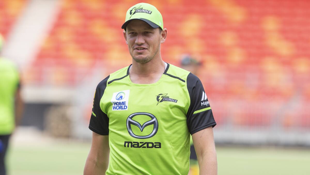WINNING FEELING: Sydney Thunder's Chris Tremain in lime green before their win at the Gabba on Tuesday night. Photo: SUPPLIED. 