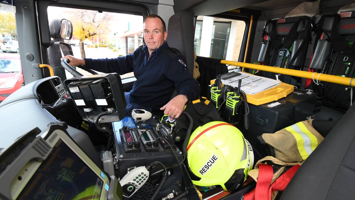 DRIVER'S SEAT: Rob Buesnel in the driver's seat of the NSW Fire and Rescue truck. Photo: JUDE KEOGH