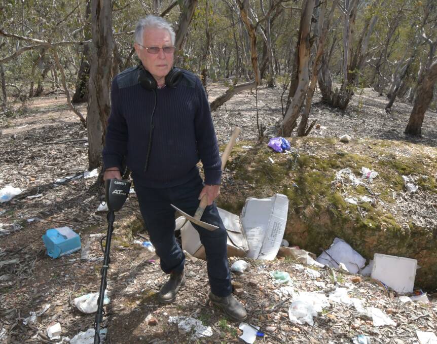 WANTING CAMERAS: John Fitzgerald with rubbish found at Ophir last week. He wants cameras or signs installed. Photo: JUDE KEOGH