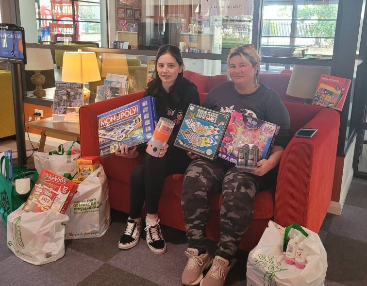 SHOW OF SUPPORT: Bathurst's Brittany Wood and Kimberly Benger with their bags of donations at Ronald McDonald House in Orange. Photo: SUPPLIED