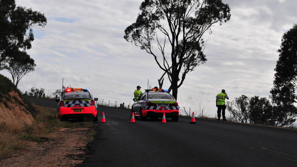FATAL CRASH: Roadblocks are in place on the Ophir Road at the scene of a fatal bike crash on Wednesday morning.