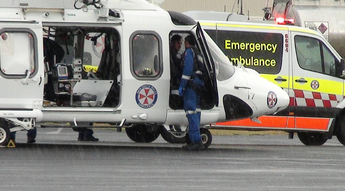 MEDICAL SUPPORT: A medical helicopter and ambulance at Bathurst airport after Sunday's incident. Photo: DAVID CARROLL/TOP NOTCH VIDEO