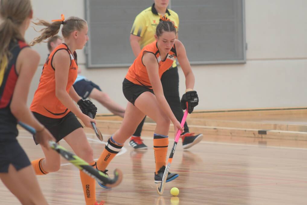 MINDFUL: Heidi Zwiers dribbles the ball up for Orange during the under 13s state titles in the city last week. Photo: JUDE KEOGH.