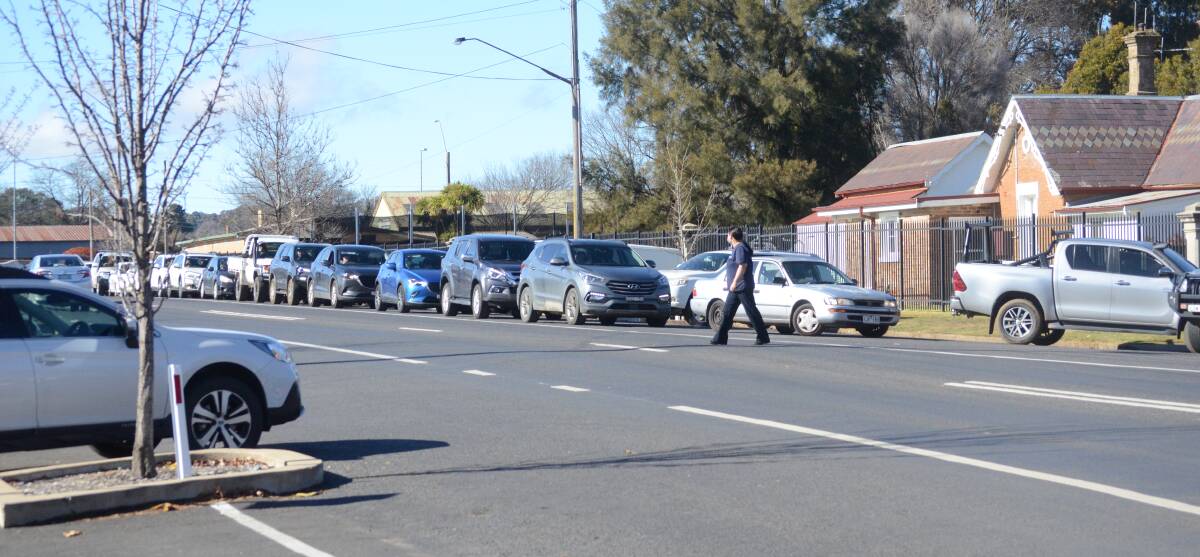 SAFETY: People lining up down the street on Monday to get COVID tested at Wade Park. Photo: RILEY KRAUSE.