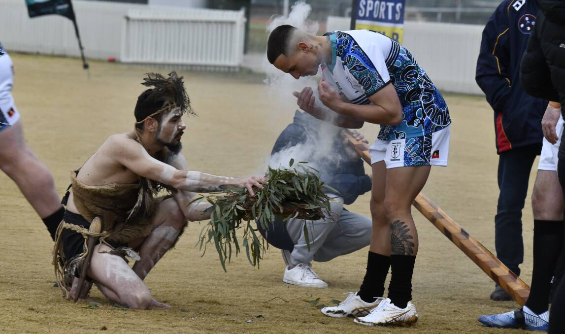 Brian Ah See and Randal Dowling taking part in the smoking ceremony prior to the Woodbridge Cup clash between Orange United and Cargo Blue Heelers on July 8. Picture by Jude Keogh