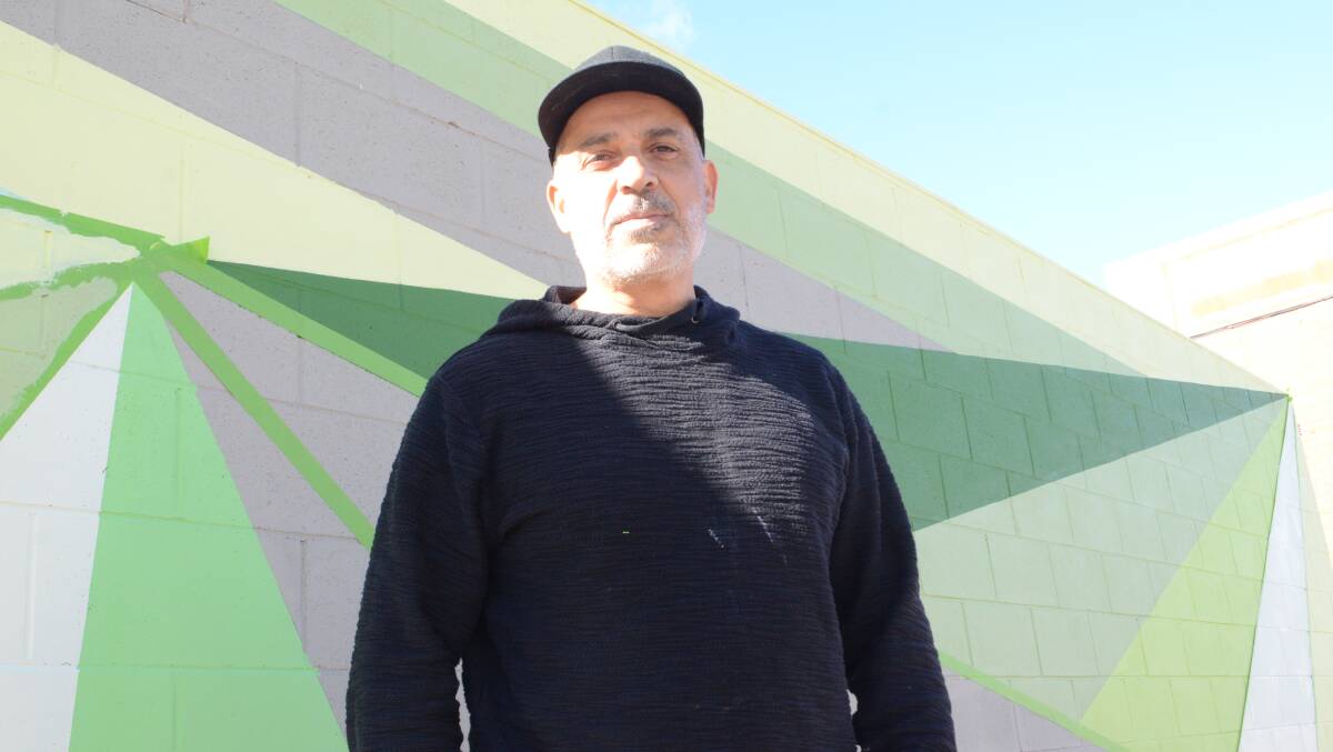 MORE TO COME: Yanni Pounartzis is the artist behind the McNamara Street artwork and says he was inspired by the region's vineyards. Photo: RILEY KRAUSE.