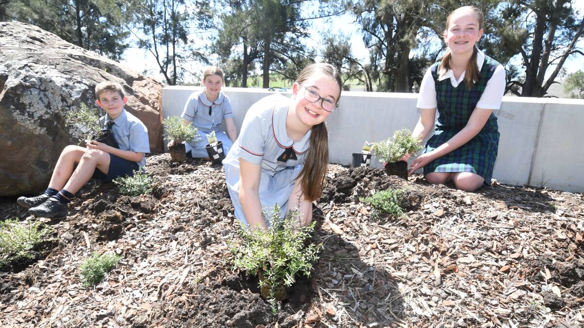 GIVING BACK: Clancy, Adeline, Holly and Cherry Wilson planting coastal rosemary at Fairbridge Children's Park. Photo: JUDE KEOGH.