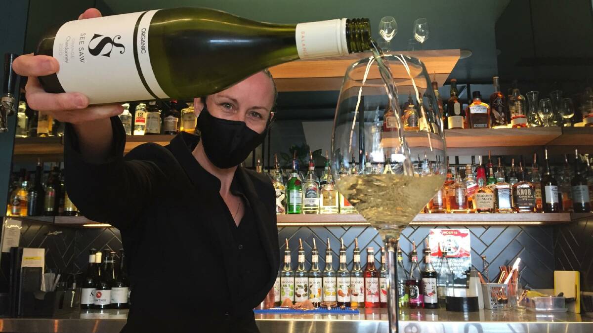 CHEERS: Kylie Byron from Whitney's Restaurant and Bar is happy to be back open and looking forward to the state's Freedom Day on October 11. Photo: RILEY KRAUSE.