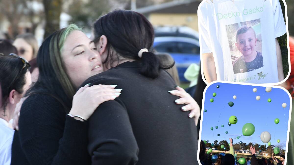 Katie Hayward is comforted by one of hundreds who gathered at Glenroi Oval to farewell he son Decklan Hayward. Pictures by Carla Freedman