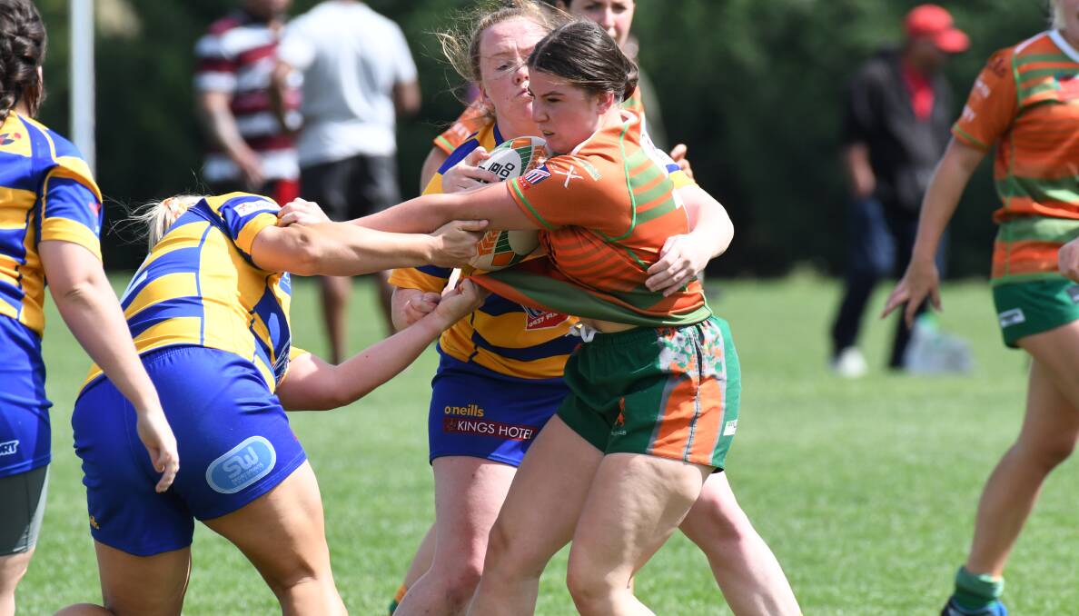 STAYING STRONG: Harmity Munday in action for Orange City as she fights off the Bathurst Bulldogs defenders. Photo: JUDE KEOGH.