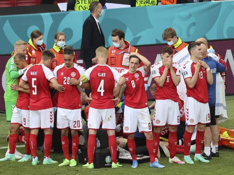 SHOCK: Denmark players surround the stricken Christian Eriksen in Copenhagen during their first game of the Euro 2020 campaign against Finland.