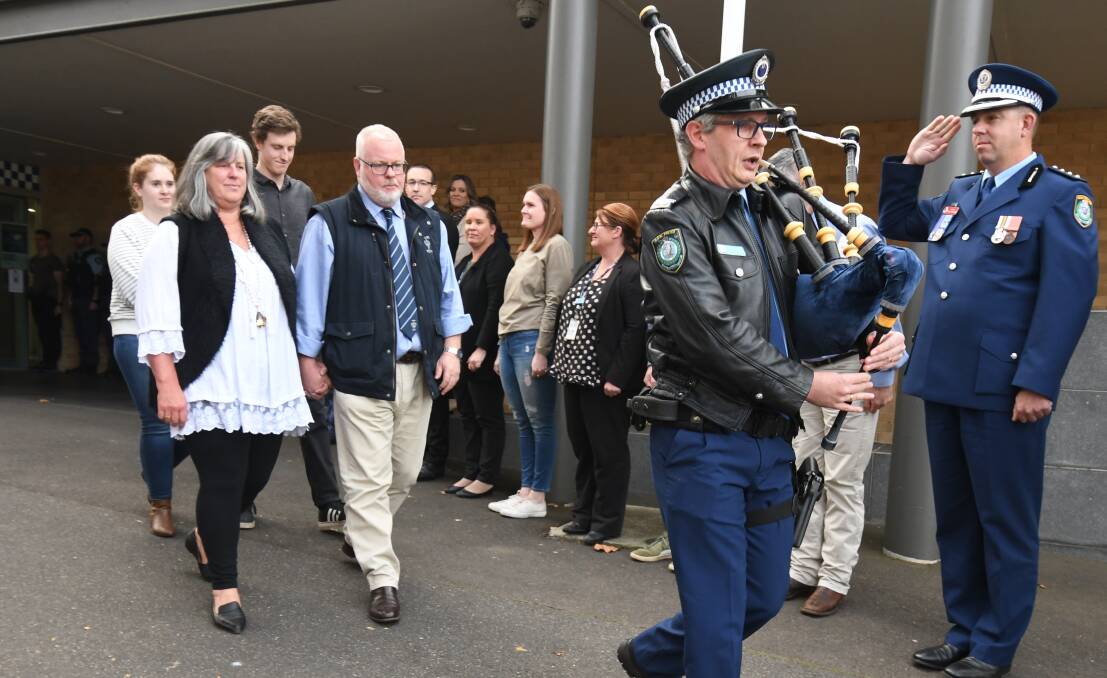 FAREWELL: Former Detective Sergeant Andrew McLean and his family were given a guard of honour as the police officer retired from the force on Thursday. Photo: JUDE KEOGH.