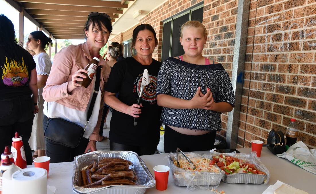 Meredith Bennett, Kylie Greatbatch and Shakaya Walker helping on the barbecue. Picture by Carla Freedman.