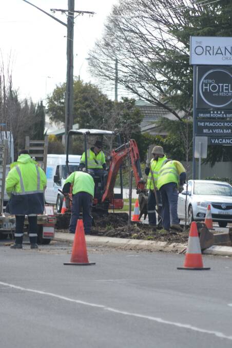 TREE RE-PLANTING: Orange City Council staff at work in Woodward Street last year. Photo: JUDE KEOGH