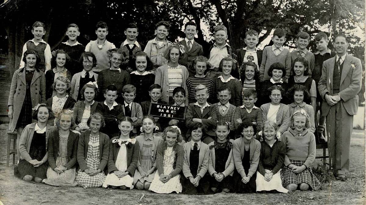 The Blayney Public School class of 1951 - 5A and 6 - for which Bob Muir (arms crossed next to the class sign) was a part of. Picture supplied.