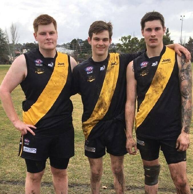 PROUD MOMENT: Orange Tigers Jake, Caleb and Tyson Hannus after their match against the Bathurst Bushrangers. Photo: SUPPLIED