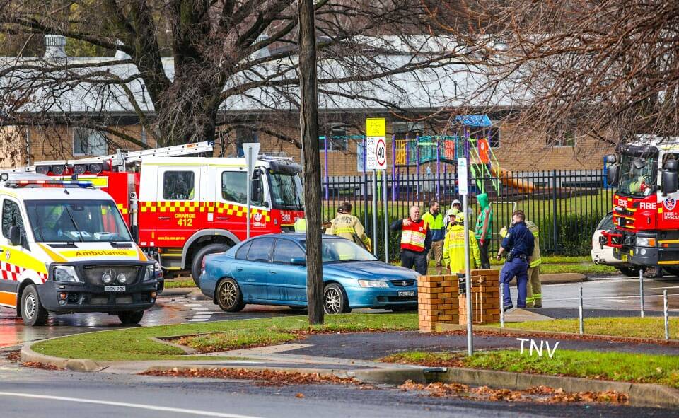EMERGENCY SERVICES: The scene of the crash outside Orange Public School on Friday. Photo: TOP NOTCH VIDEO/TROY PEARSON
