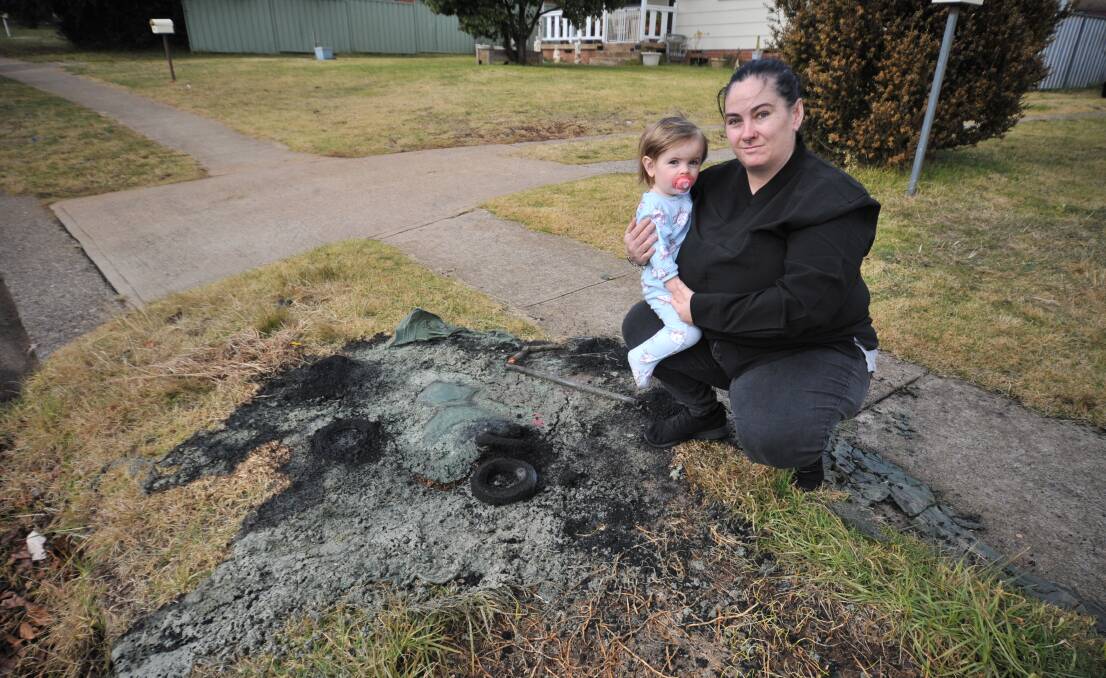 SCARED: Mel Sullivan with daughter Mia Ogilvie outside their house where their bins were set on fire earlier this week. Photo: JUDE KEOGH.