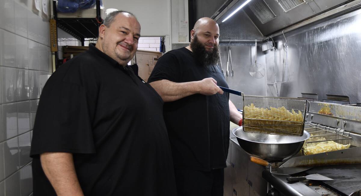 Angelo and John Giameos work hand-in-hand at the King's Takeaway kitchen. Picture by Carla Freedman