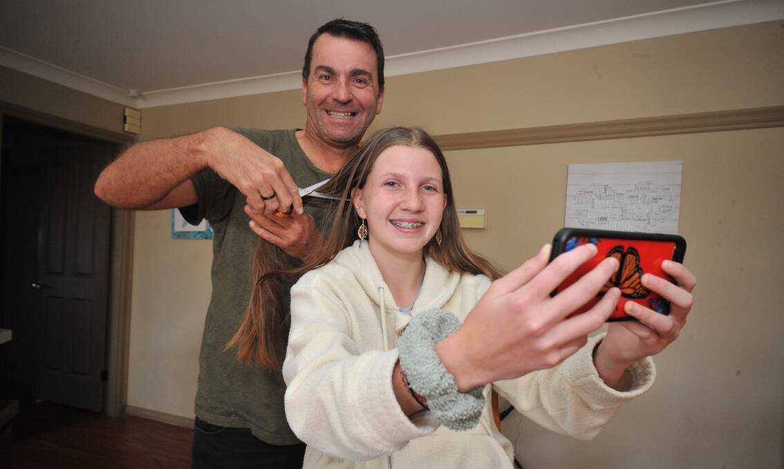 WELL DONE: Brett and Tegan Sammut are over the moon after the year eight student raised more than $2000 as she prepares to shave her hair off. Photo: JUDE KEOGH.