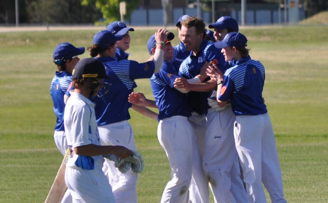 WINNERS: Colts cricketers embrace Harry McGregor after taking the final wicket against Dubbo.
