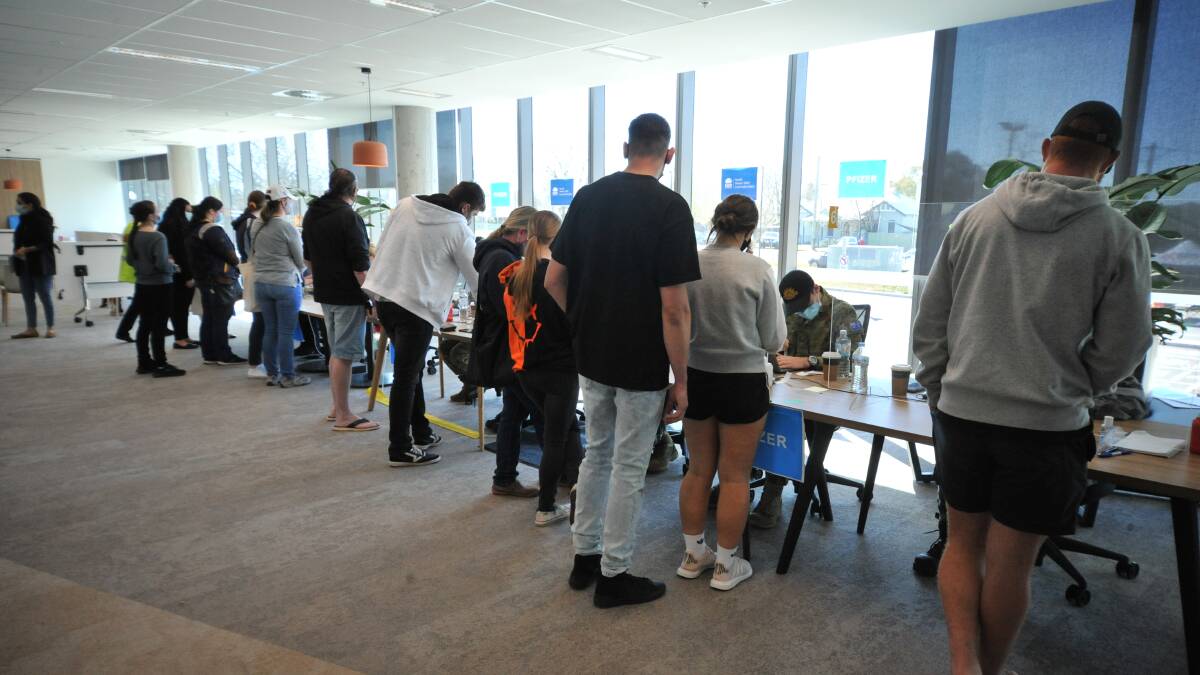 HIGH NUMBERS: People lined up at the pop-up vaccine hub in Orange over the weekend. Photo: JUDE KEOGH. 