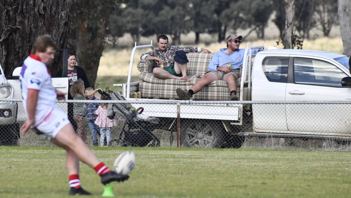 A pair of spectators brought out the 'couch on the back of the ute' trick to watch Manildra take on Cargo. Picture by Jude Keogh.