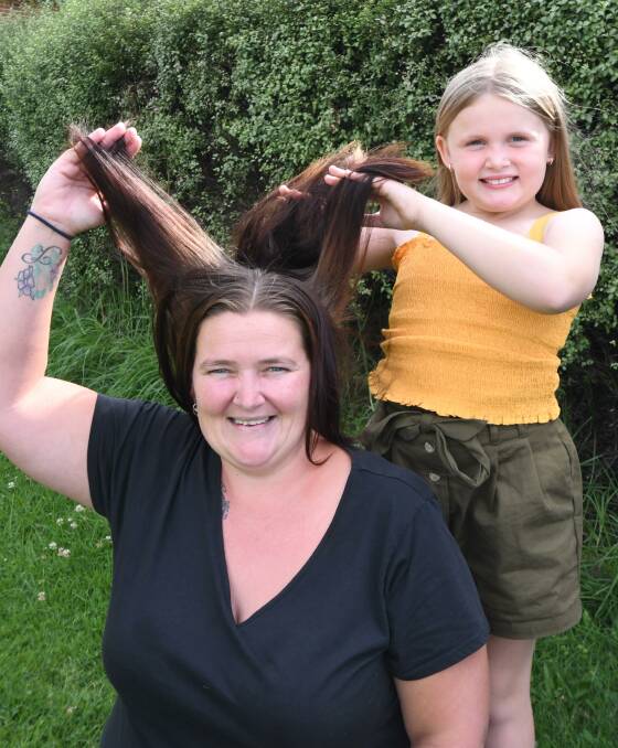 GETTING THE CHOP: Kylie Shelker and Hayley Hodges are both hoping that Kylie raises enough money to shave off her hair. Photo: JUDE KEOGH.