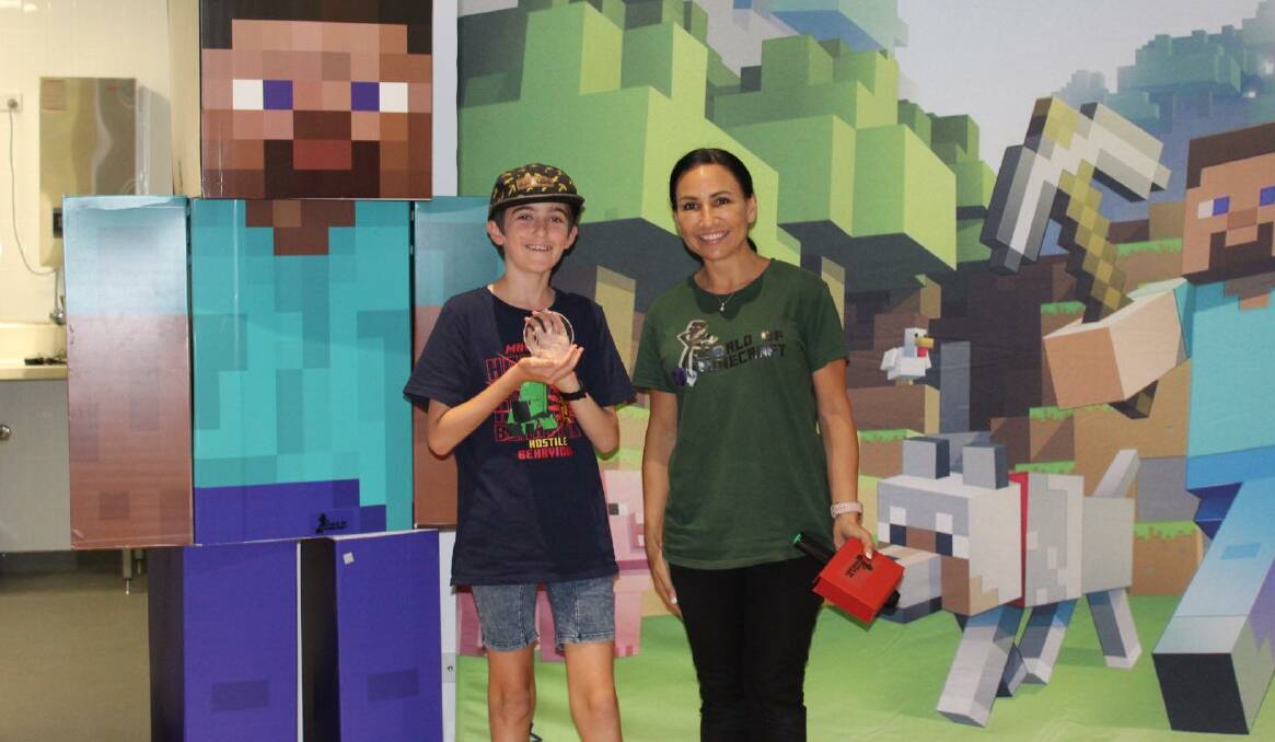 EXCITING: Cayden Holmes and World of Minecraft's Noelene Callaghan at a recent holiday workshop in Camden. Photo: SUPPLIED.