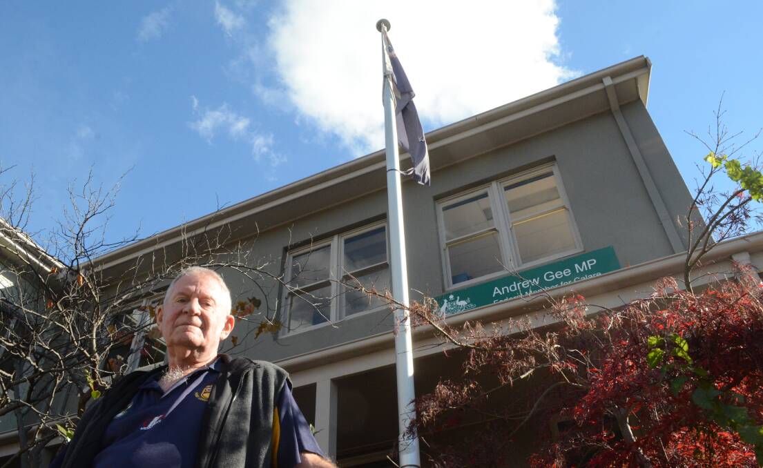 DISRESPECT: Noel Clegg outside MP Andrew Gee's office at the corner of Anson and Kite Street where a torn flag flies. Photo: RILEY KRAUSE