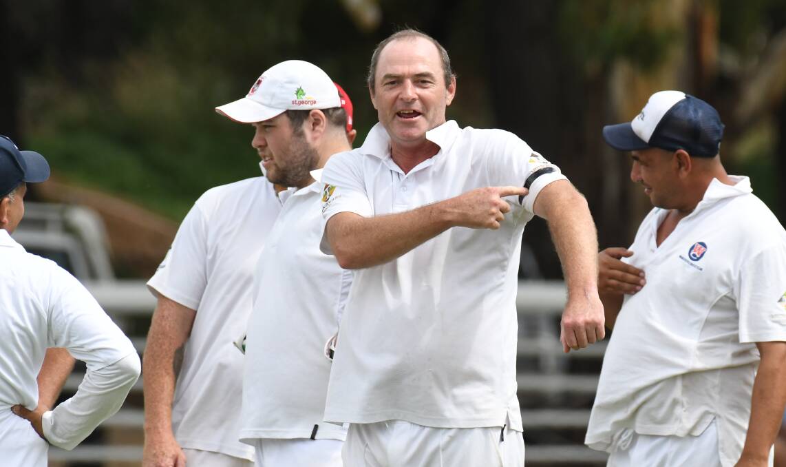 MEMORIES: Gladstone's Troy Pearson points to the black armband on a day where tributes were paid to the late Shane Warne and Rod Marsh. Photo: JUDE KEOGH