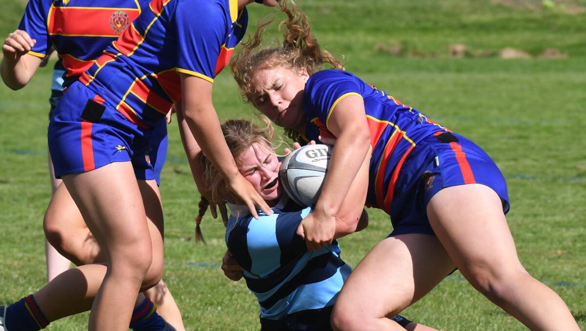 ROUGH: Josie Clark feeling the full brunt of the defender in Kinross' game against James Sheahan in the opening schoolgirls 7s day. Photo: JUDE KEOGH 