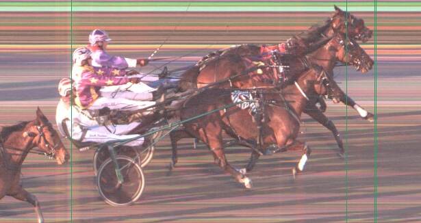BATTLE FOR SECOND: Renee Dale (centre) holds out Sophie Brown (furthest from camera). Photo: HARNESS RACING NSW