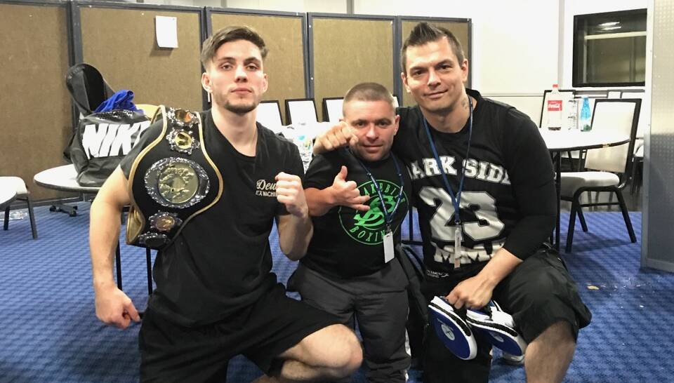 KING OF THE RING: Main event winner Ty Telford sports his title belt, alongside Snakebite Boxing's Jamie Fallon and trainer Uro Pavi. Photo: SUPPLIED