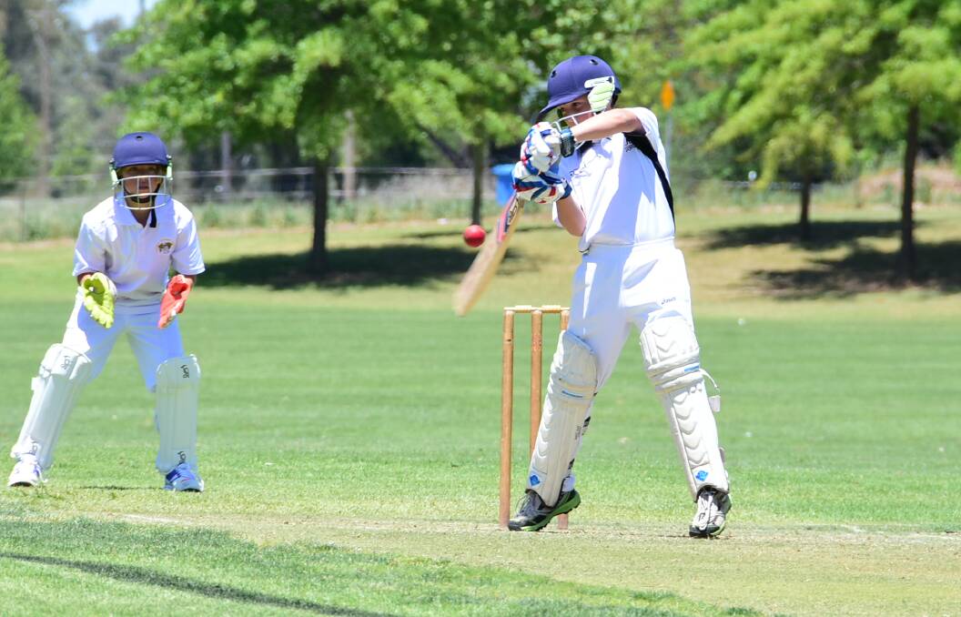 CUTTING EDGE: Bathurst's Blayde Burke slashes one of over point in Mitchell's under-12 win on Sunday. Photo: ANDREW FISHER
