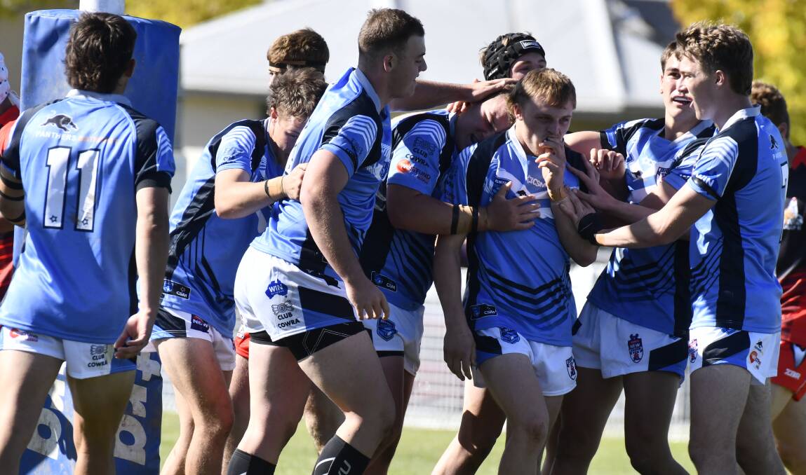 Group 10 players celebrate a try during last year's match against Group 11. Picture by Jude Keogh.