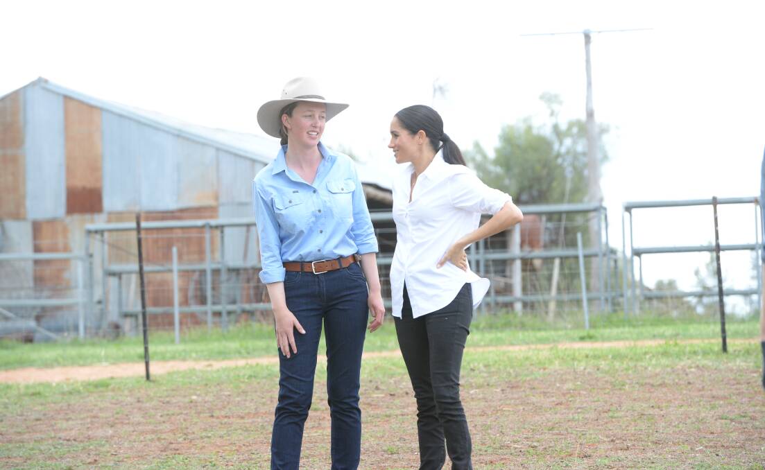Laura Woodley, 23, gets to have a personal chat with Meghan Markle, the Duchess of Sussex, on the Royals tour to Mountain View Farm near Wongarbon. Meghan was ready for some farm help and put out some cottonseed for the cattle and knew about soil moisture issues. She later gave the Woodleys a personally baked banana bread loaf. "We always take a plate when we're visiting," Meghan said of the Markle US tradition. Photo by Rachael Webb.
