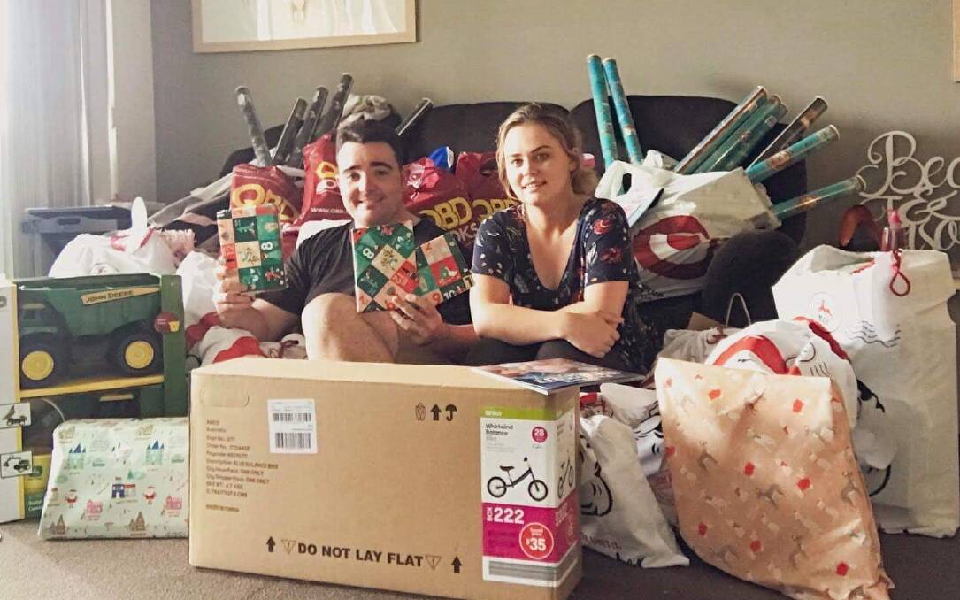 JOY TO CARGO: Jason Owen (left) and fiancée Becy will bring Christmas presents to Cargo families on Sunday. 