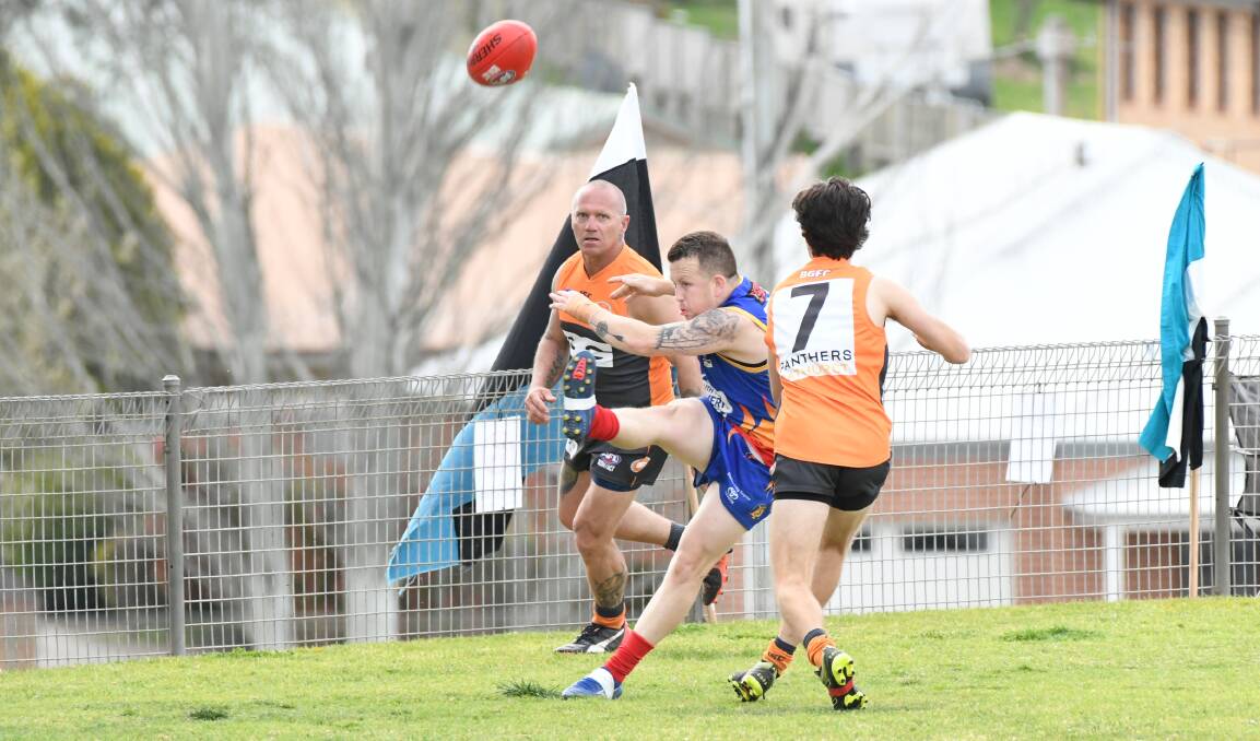 GIVING IT ALL: Joey Hedger puts boot to ball during the Demons' loss to the Bathurst Giants on Saturday. Photo: PHIL BLATCH