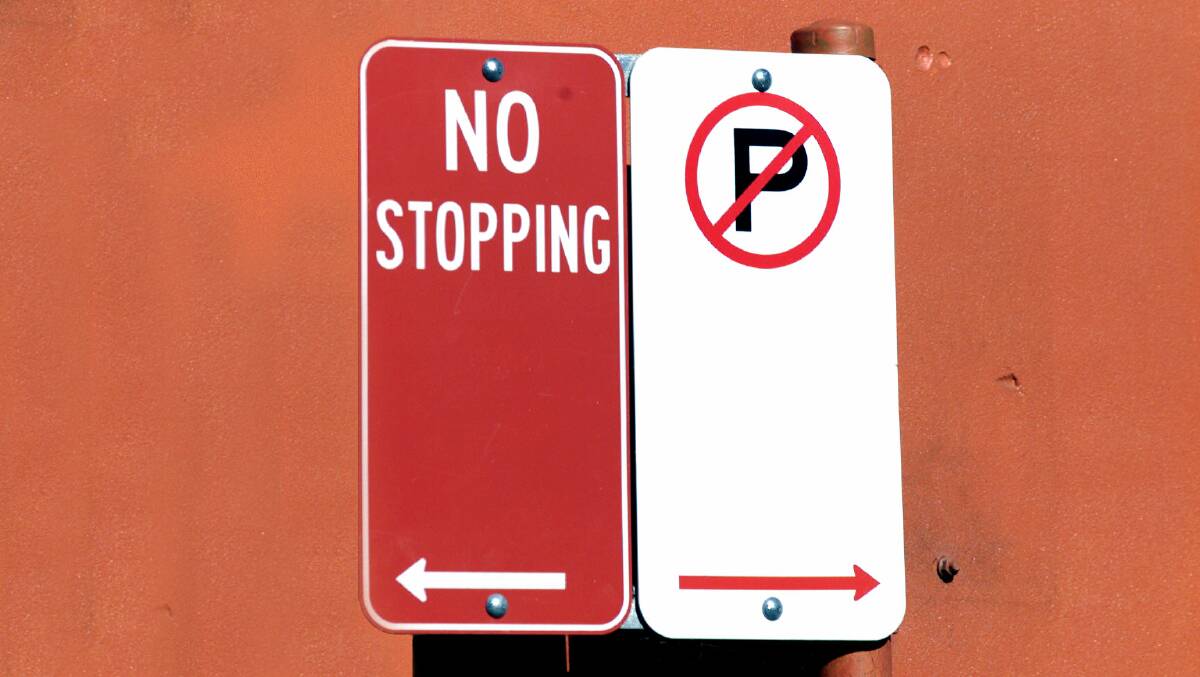 SETTING THE RULES: The no parking sign on the right allows cars to stop for two minutes, or five with a mobility permit.