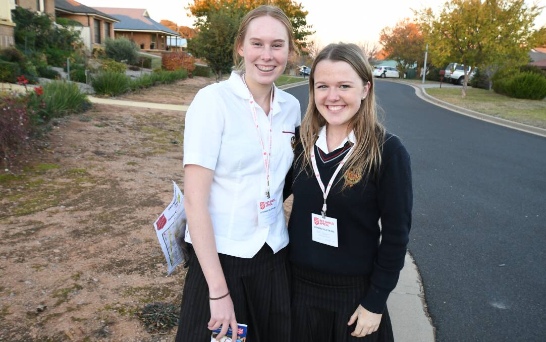 FRIDAY APPEAL: James Sheahan Catholic High School's Olivia Richards and Beth Mulligan hit the streets early on Friday evening to kick off The Salvation Army's Red Shield Appeal. Photo: JUDE KEOGH 0526jksalvo1