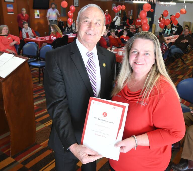 RED AWARDS: Orange City Council's Russell Turner presented CSU's Terri-Lee Duffy with an award to recognise her contribution to a cross campus Playing Right Program initiative. Photo: JUDE KEOGH 0718jkcsu6