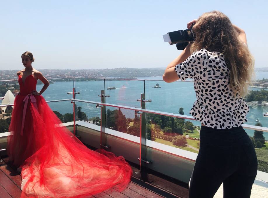 CAMERA ACTION: Annie Kind on location with a model showing off the Vera Wang bridal collection. Photo: supplied.
