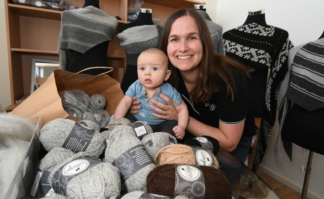 MILLS MARKET: Four month old Arthur Hulme is with mum Nadine Hulme at the family's workshop on Lords Place, surrounded by wool destined for Sunday's Rotary Market. Photo: JUDE KEOGH 0502jkwool1