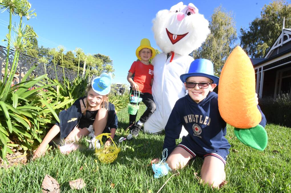 EGG HUNT: Alexandra, Thomas and William Karrasch with the Easter bunny ahead of Saturday's chocolate search. Photo: JUDE KEOGH
