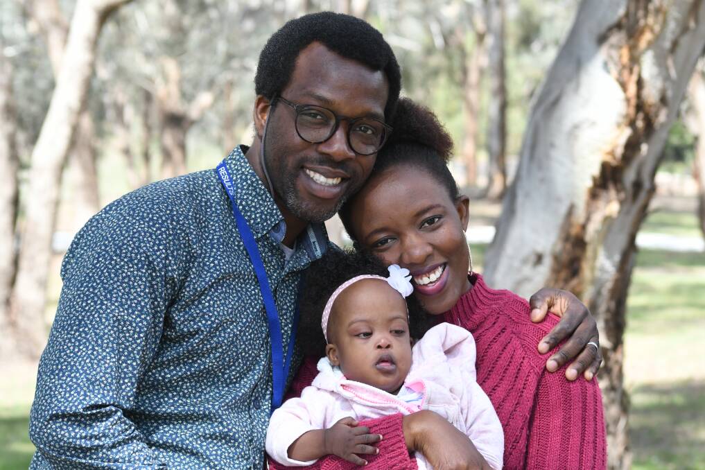 NEW HOME: Ola Tawose, his wife Shola and baby Hazel have found a house with a big backyard for their family. Photo: JUDE KEOGH 1109jkfamily2