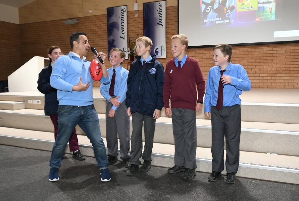 SCHOOL VISITS: Engaging author Felice Arena entertains St Mary's Catholic Primary School students Ruby Kane, Lachlan Roberts, Oliver Perkins, Angus Thompson and Will Corben. Photo: JUDE KEOGH 0522jkauthor1