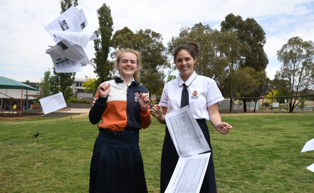 DONE AND DUSTED: Hillary Owen and Laura Sharp celebrated the end of their HSC exams on Friday. Photo: JUDE KEOGH 1102jkhsc3