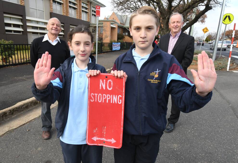 SCHOOL SAFETY: Orange City Council's City of Orange Traffic Committee Chair Russell Turner, Catherine McAuley Catholic Primary School year 5 students Darcy Franklyn and Heath Vaughan with principal Michael Croke. Photo: JUDE KEOGH